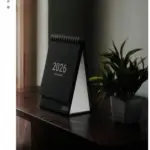 small black desk calendar saying year: 2026